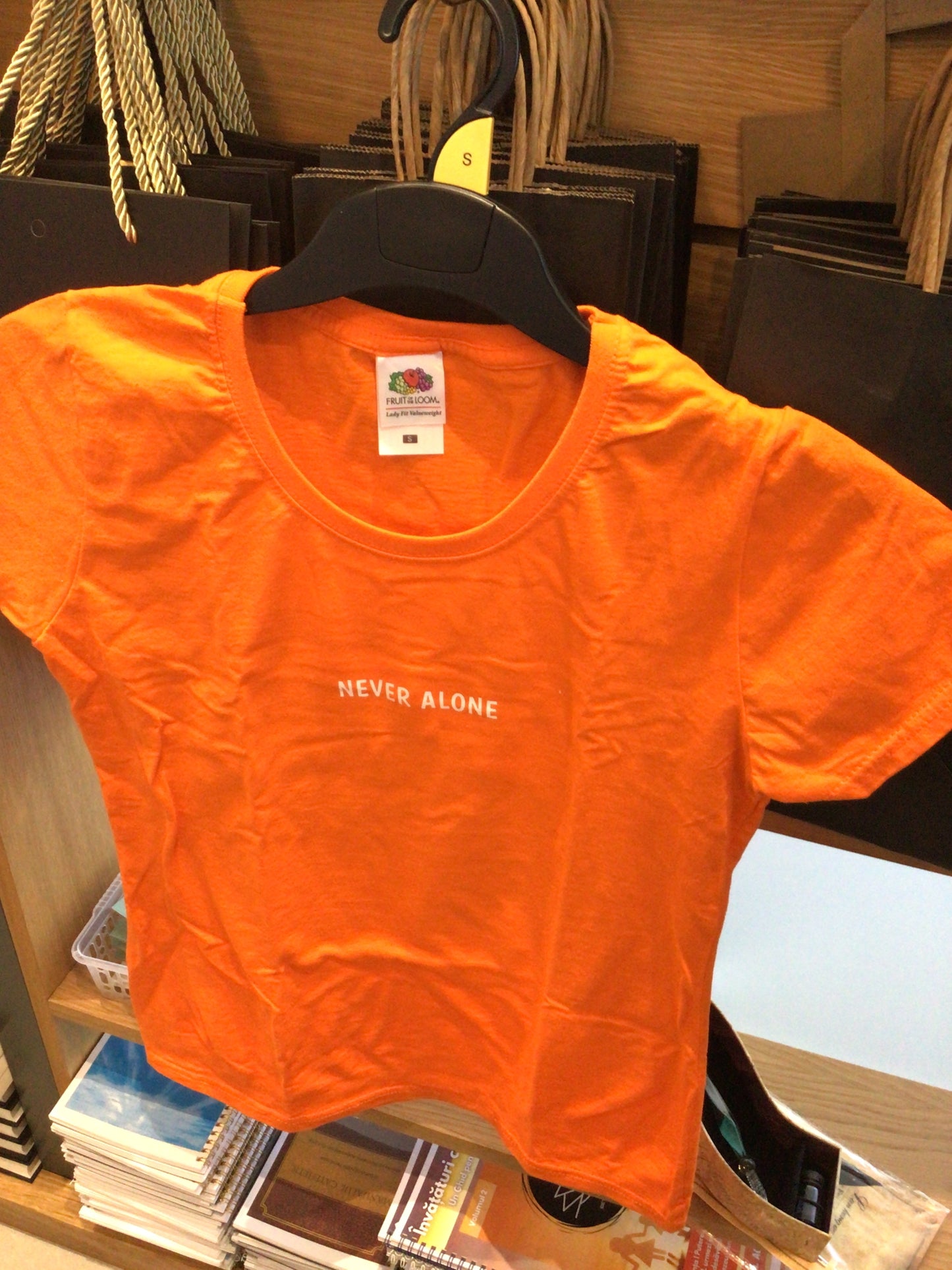 Orange t-shirt “Never alone”